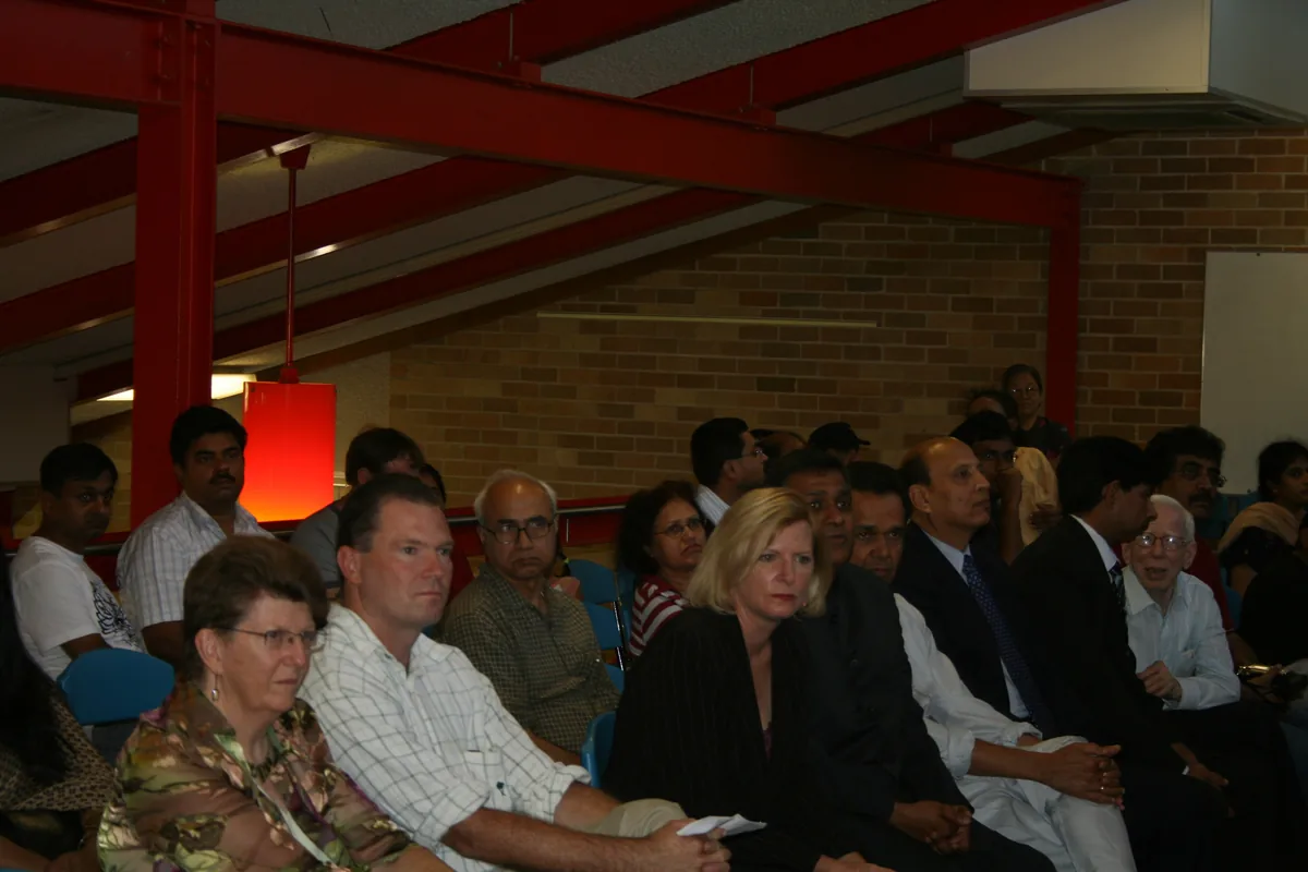 Invited guests and community members seated together at the Hindi school inauguration